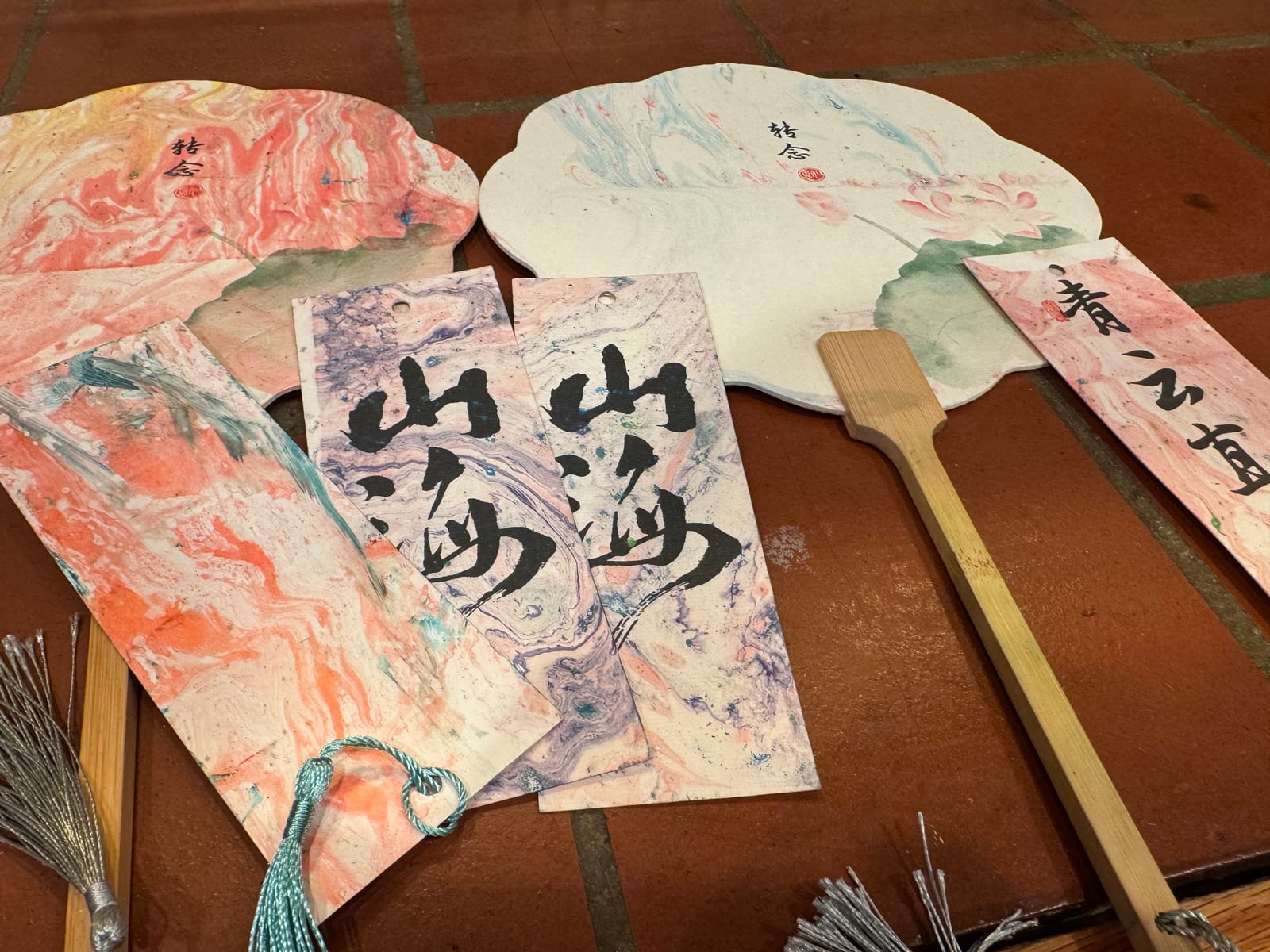 A finished premade marbled lacquer fan