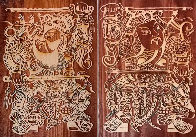 Two carved wooden Guardian blocks side by side, ready for rubbing prints