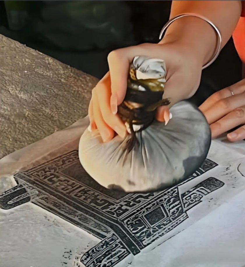 A carved Guardian wood block for hands-on rubbing prints